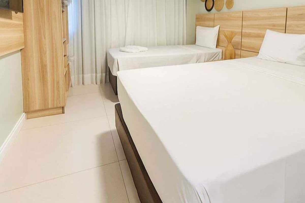 Superior Triple Room | Minibar, in-room safe, individually decorated, desk