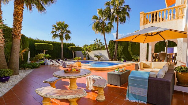 A poolside area with a hot tub, lounge chairs, and a dining table. - Villa AURORA by Abahana Villas (Benissa)