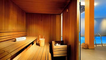 A wooden sauna with benches and a bench with a towel.