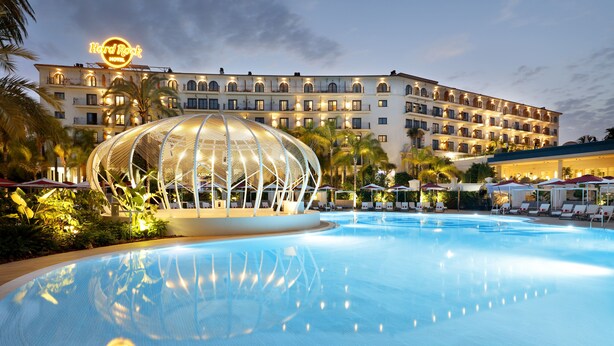 A hotel with a swimming pool, a large dome structure, and a well-lit building facade. - Hard Rock Hotel Marbella – Puerto Banús (Marbella)
