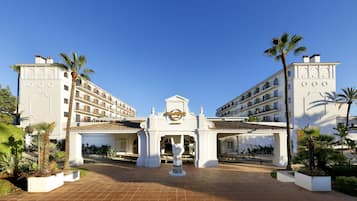 Experience the grand entrance of this iconic hotel, featuring a striking facade with arched windows and balconies.