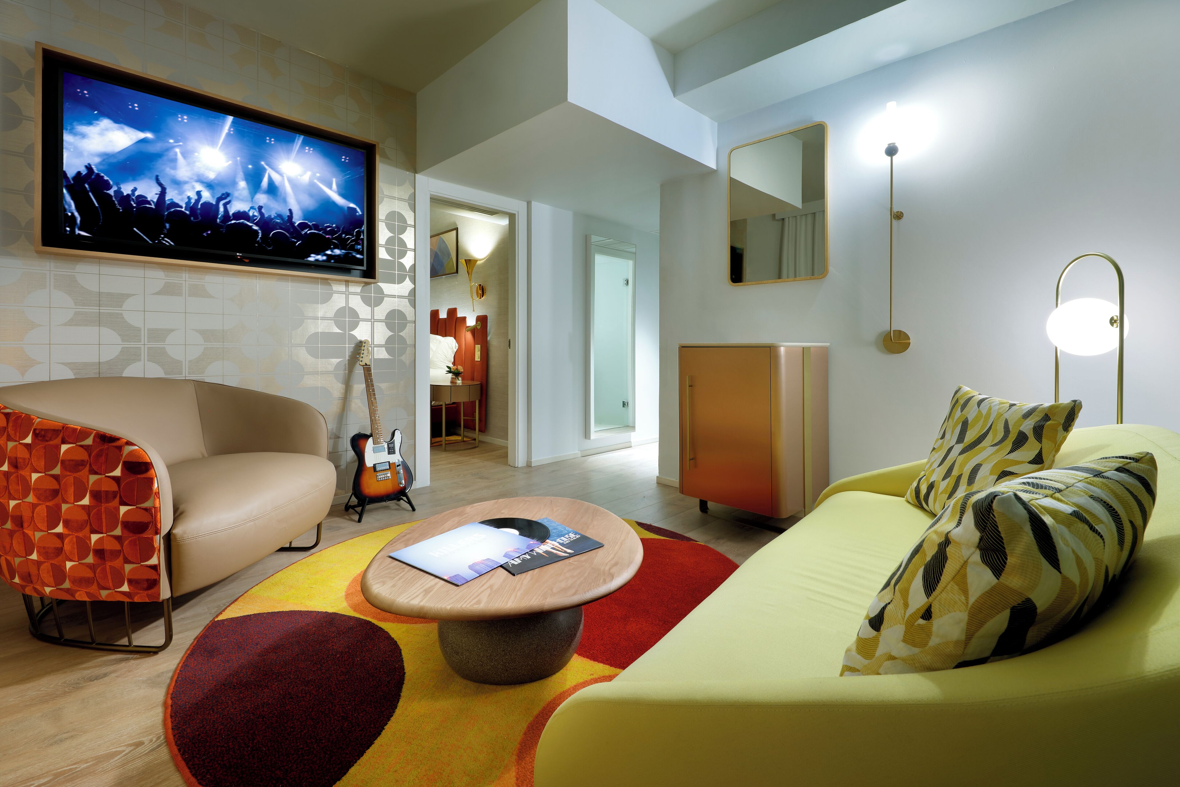 A modern living room with a television, sofa, and a coffee table.