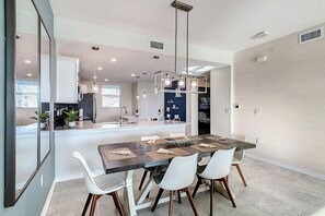 Modern dining area with stylish table opening to the kitchen