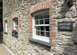 A stone building with a sign reading "SANCTUARY COTTAGE." - Riverside Idyll - the Perfect Cornish Sanctuary (Truro)
