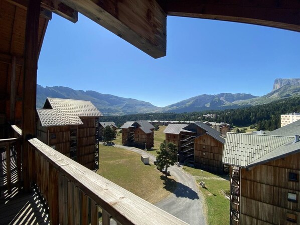 A wooden cabin-style building with a view of a mountainous landscape.