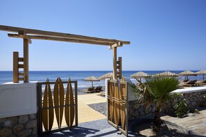 On the beach, black sand, free beach cabanas, sun-loungers