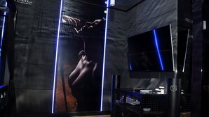 A modern interior with a large poster, a flat-screen TV, and a sound system. - Apartament BDSM Luxxx Częstochowa (Czestochowa)