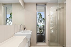 Bathtub, hair dryer, towels, shampoo