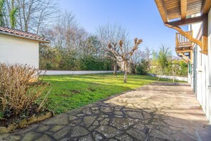 Stroll through the serene courtyard, surrounded by lush trees and a beautifully manicured lawn.