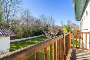 Enjoy a serene view of the well-maintained garden from this balcony.