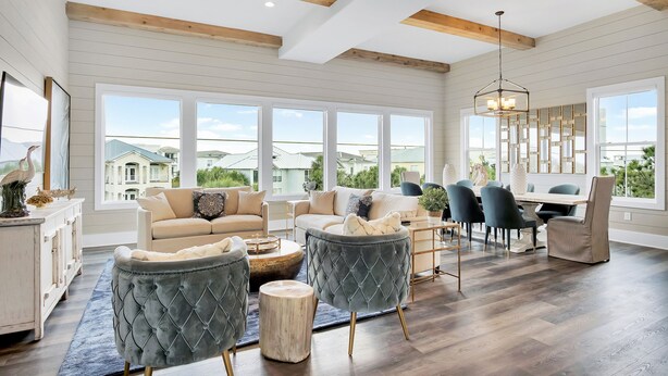 A spacious living room with a large dining area, wooden beams on the ceiling, and large windows offering a view of the neighborhood. - Aces High|Private Beach Access|Private Pool|Golf Cart (Santa Rosa Beach)