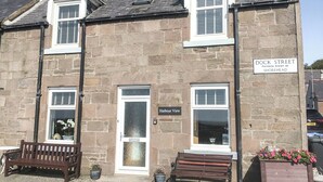 A two-story stone building with a sign indicating 'Dock Street' and 'Harbour View.' - 3 bedroom accommodation in Johnshaven, near Stonehaven (Johnshaven, near Stonehaven)