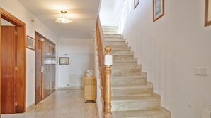 A marble staircase with wooden balusters and a radiator on the wall.