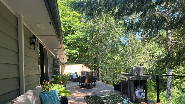 An outdoor deck with a sofa, chairs, and a grill. - Well-furnished Hiker's Retreat, Centrally located for visiting the ONP; Sleeps 8 (Port Angeles)