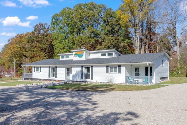 A single-story house with a front porch, a garage, and a driveway.