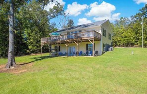 Relax on the upper-level balcony or unwind on the front porch amidst a serene natural setting.