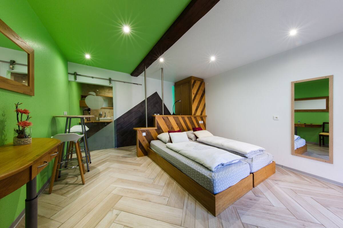 A room with a bed, a desk, and a chair.