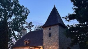 A stone building with a tower, a covered patio with chairs, and a ladder leaning against the wall. - Authentic Quercy house, between Périgord and Quercy (Peyrilles)