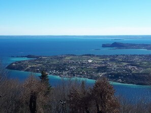 A coastal town with a view of the sea and a prominent hill in the distance.