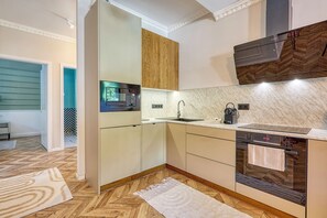 A modern kitchen with a built-in Bosch microwave, a sink, and a dishwasher.