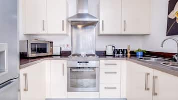 Microwave, oven, dishwasher, dining tables