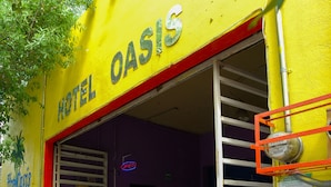A hotel entrance with a bright yellow facade, a red trim, and a sign that reads "HOTEL OASIS." - OYO Hotel Oasis, Monterrey (Monterrey)