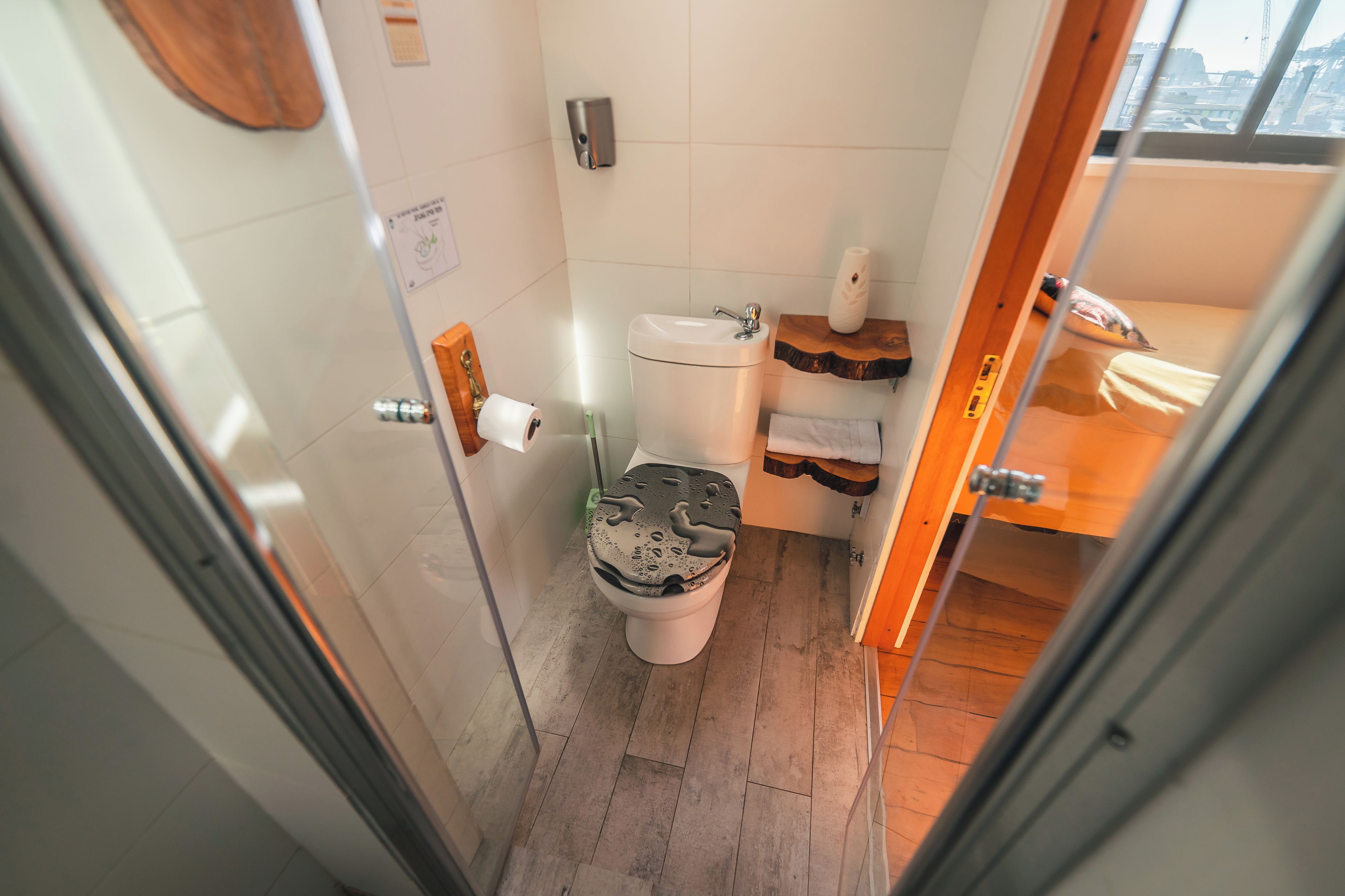 A compact bathroom with a toilet, a sink, and a shower area.