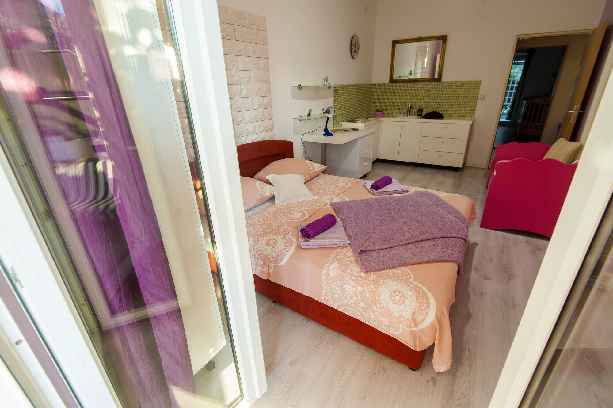 Ein Schlafzimmer mit Bett, Nachttisch und Schreibtisch mit Stuhl.