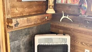 Een hoekzaak met een houten wand, een witte radiator en twee abstracte schilderijen.