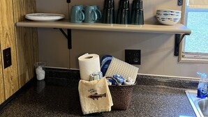 Une cuisine dotée d’un plan de travail en granit, d’un meuble en bois et d’une fenêtre offrant une vue agréable.