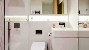 A modern bathroom with a toilet, bidet, and a large mirror. - Bright Spacious Modern One Bedroom Apartment (1) (London)