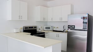 Fridge, microwave, stovetop, coffee/tea maker
