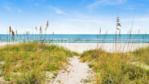 A beach path leading to the ocean with clear skies. - Gulf Front Retreat | Beachfront Living | West Beach Favorite (Gulf Shores)