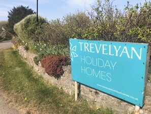 A sign for Trevelyan Holiday Homes with a website URL. - 2 bedroom accommodation in The Lizard (The Lizard)