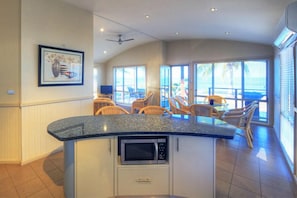 Beachfront Spa Villa (3BR) | Private kitchen | Electric kettle, dining tables - Tasman Holiday Parks - Rollingstone (Rollingstone)