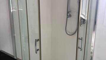 Shower, towels, soap, toilet paper