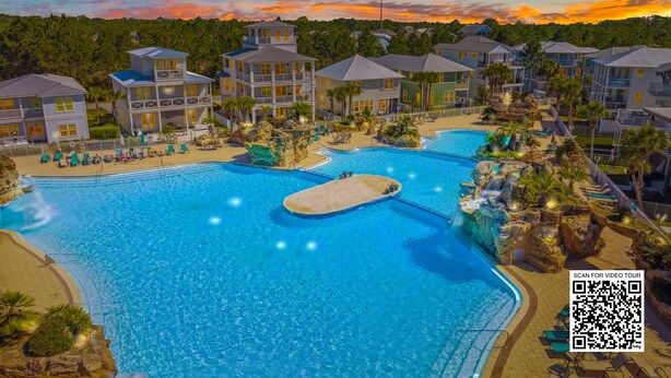 Un complexe hôtelier doté de plusieurs piscines, d’une plage et de différents bâtiments.