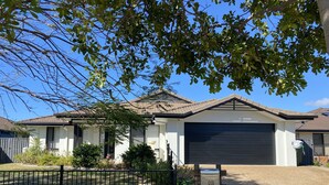 A residential house with a garage, a mailbox, and a fenced yard. - Bargara - Everday's a Holiday! (Bargara)