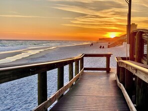A wooden boardwalk leading to a beach with a sunset in the background. - 3BR/2BA - Beach - Heated Pool - Centrally Located (Destin)