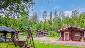 A rustic cabin with a porch and a swing set in a forested area. - Korvenpää by Interhome (Joutsa)
