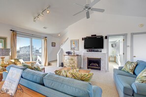 Relax in this stylish living room with a fireplace, city view, and comfortable seating area.