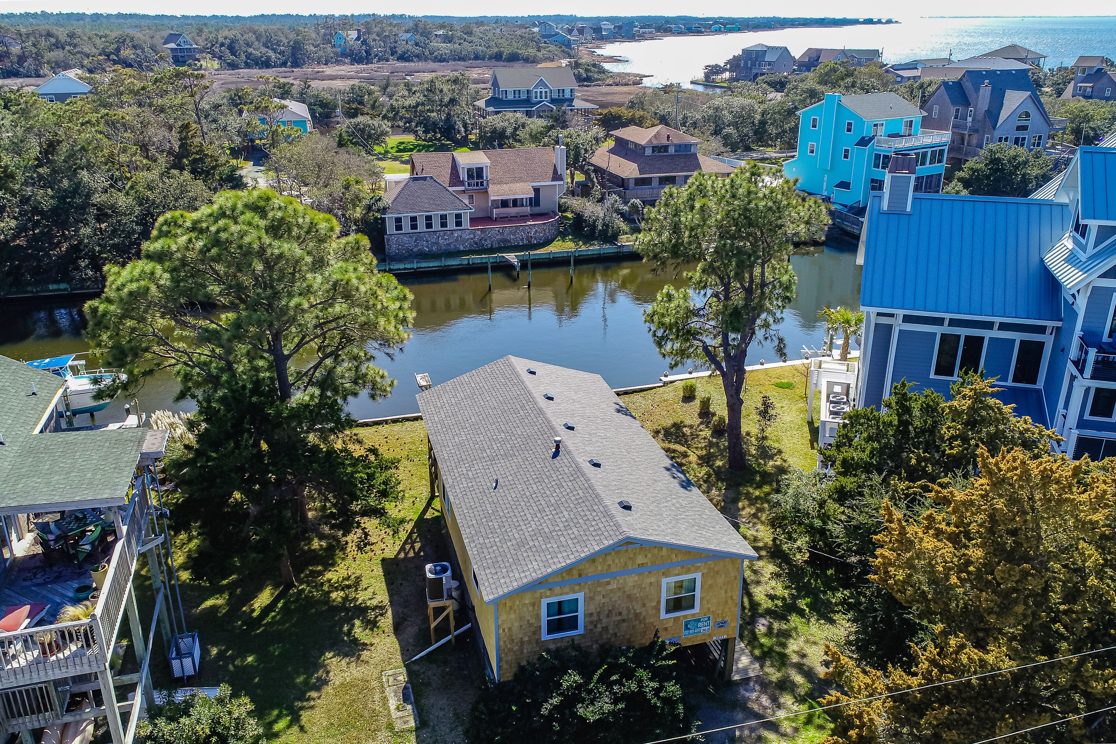 Waterfront home on a scenic canal with a dock, screened porch & fast WiFi