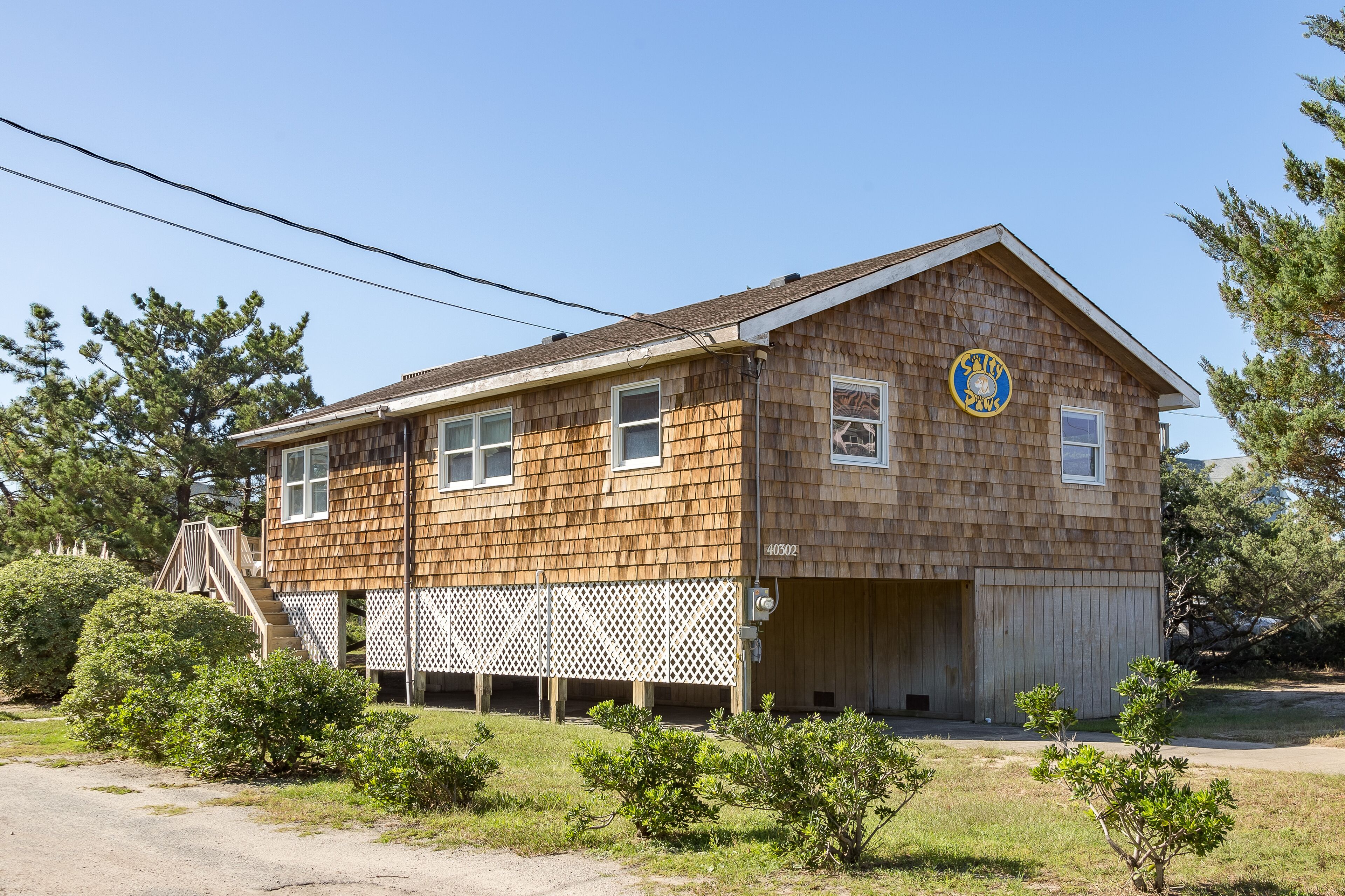 Semi-oceanfront dog-friendly home with private hot tub, decks & shared pool