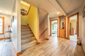Stunning interior space with a grand staircase, large tiles, and a cozy reading nook.