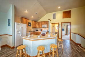 Enjoy cooking in this well-equipped kitchen with a central island and modern appliances.
