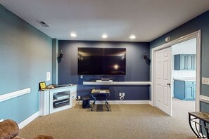 Relax in this stylish living room with a large flat-screen TV and entertainment unit.