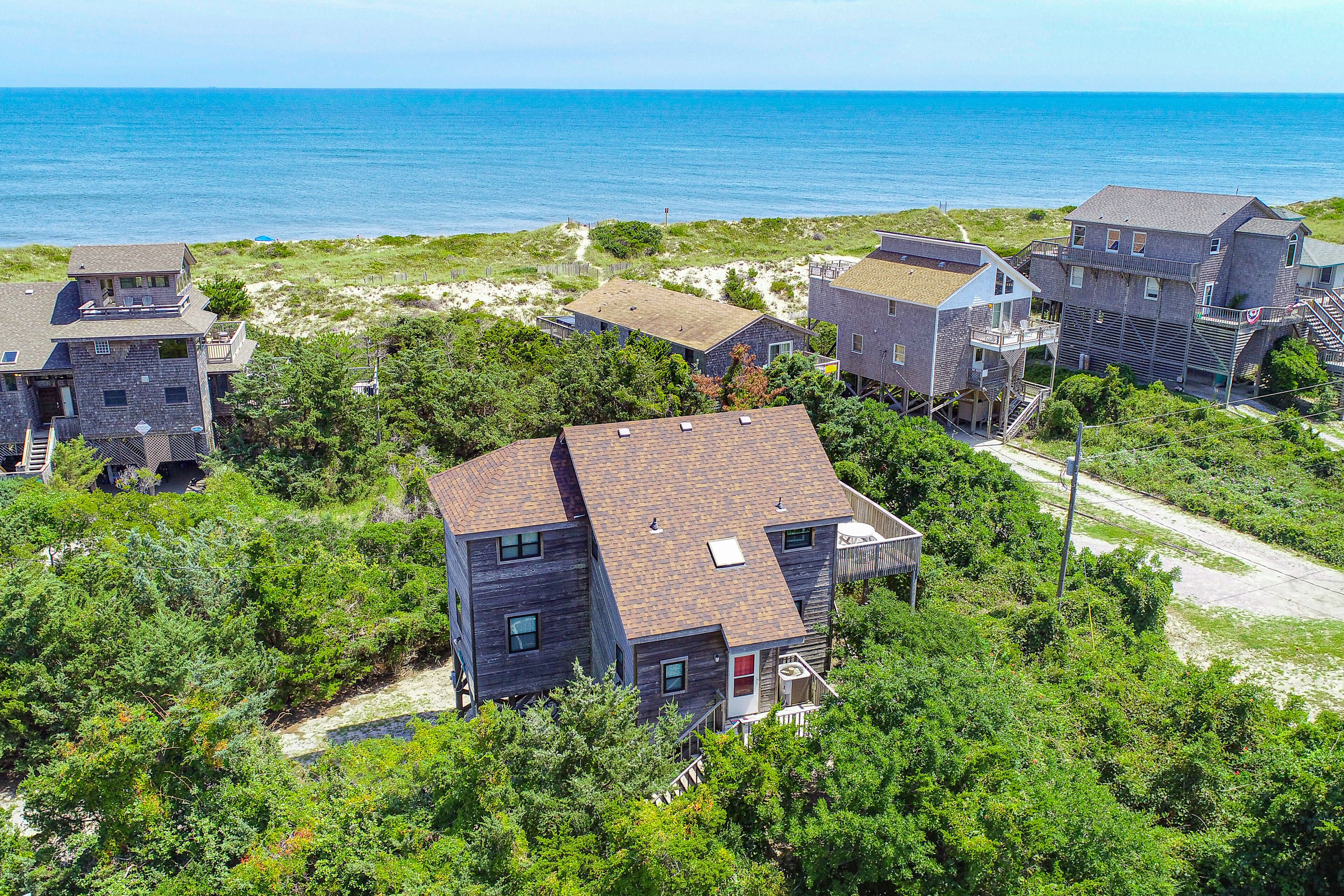 Large ocean-side home just steps from beach with pool access & central AC