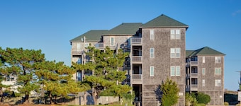 Fun-filled vacation home steps from beach with outdoor pool, AC, W/D, & balcony