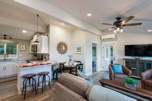 Relax in a spacious living area with a central island, dining table, and comfortable seating.