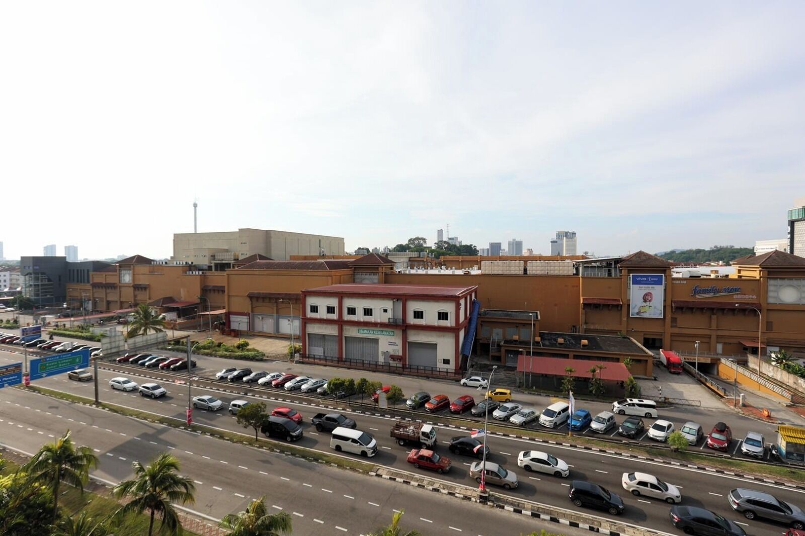 A multi-story commercial building with a parking lot in front.